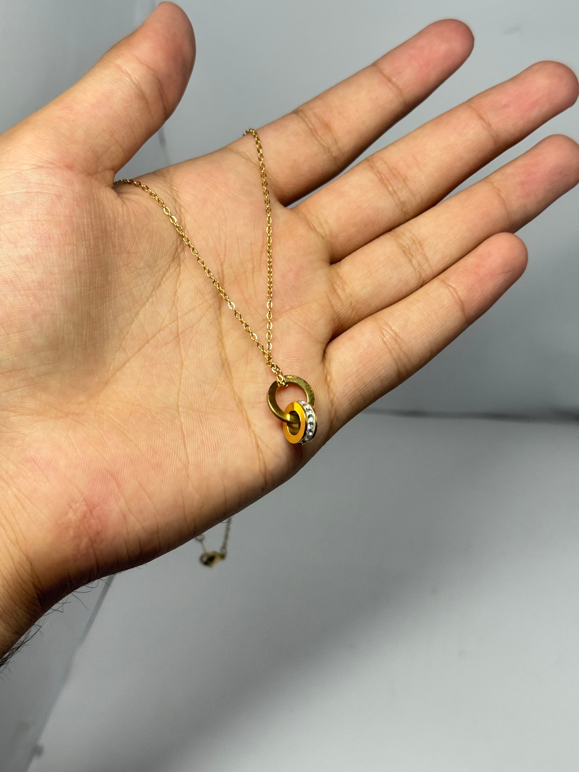 Elegant Interlocking Gold-Tone Pendant Necklace with Crystal Detailing - Glimzie
